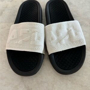 Women’s APL slides size 9.  White strap, black soles. Good condition